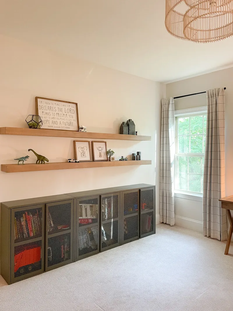 The shelf wall straight on, its run of mesh cabinets stretching beneath a rattan pendant