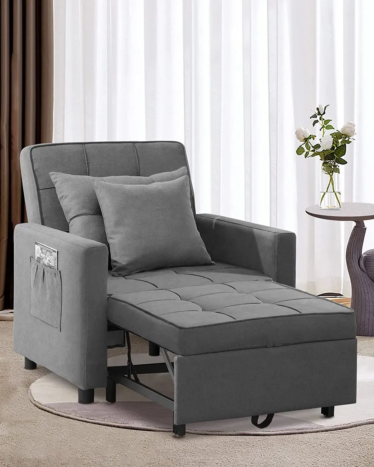 A grey fabric recliner opened out flat, its remote tucked into a side pocket