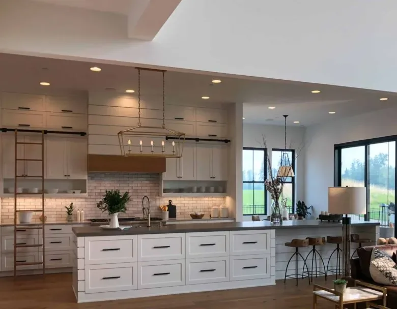 white kitchen island with chandelier