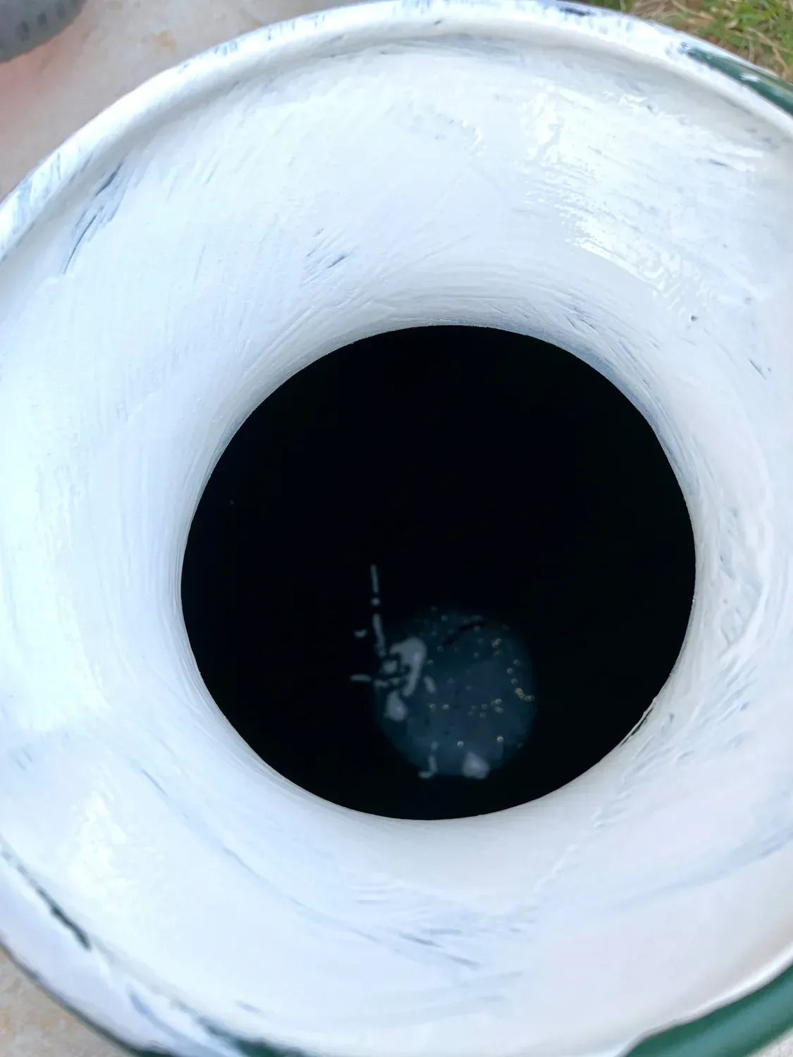 The vase rim painted without primer, the brush leaving heavy white streaks