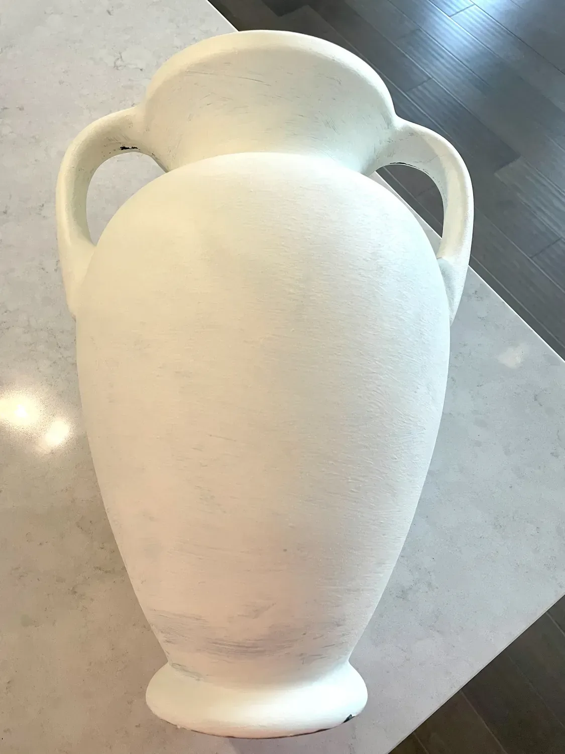 The first coat of baking-soda paint dried to a chalky matte white on the vase