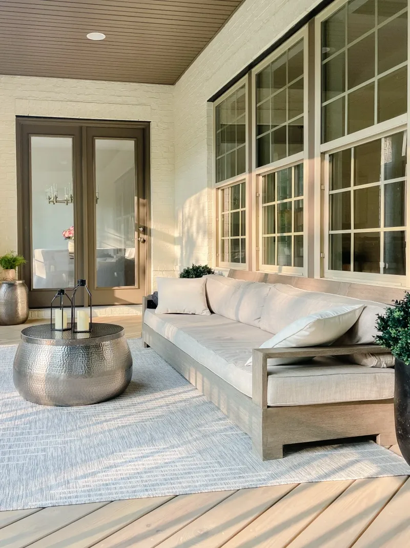 Long teak sofa on the porch, beside the French doors into the house