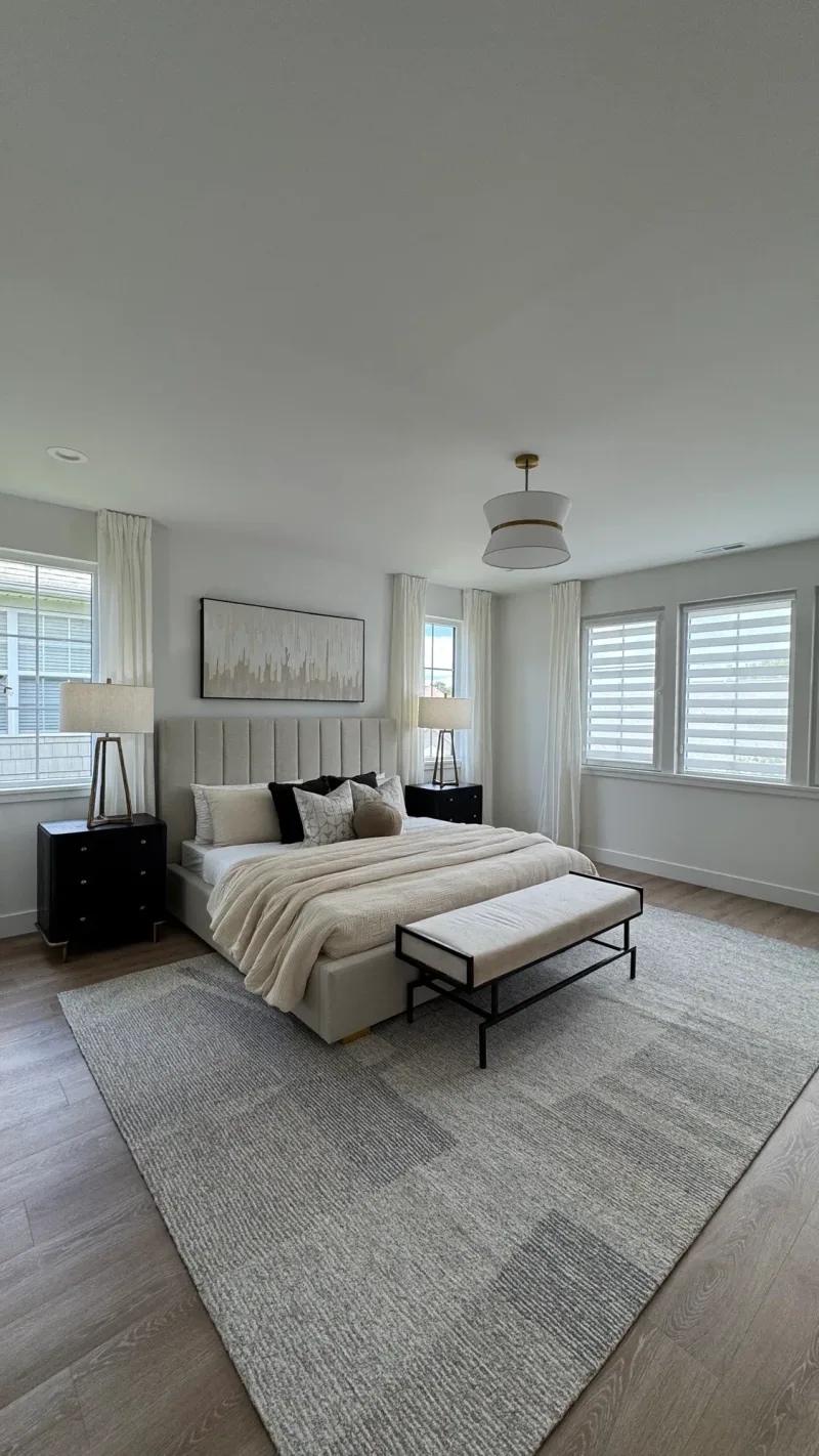 The same bedroom from the other side, with three shuttered windows