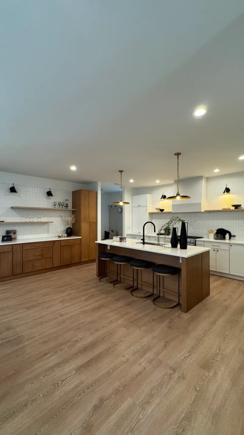 Kitchen in walnut and white, with black sconces and a run of open shelves