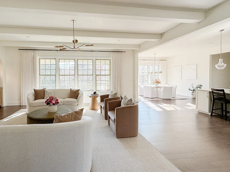 Open plan view from the living room through to the dining table and kitchen counter beyond