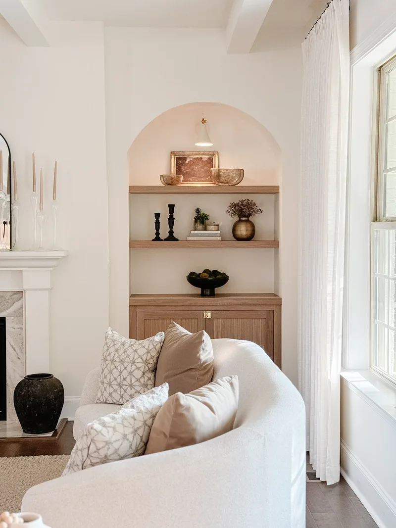 The niche straight on, sofa cushions in the foreground and the marble mantel at the left edge