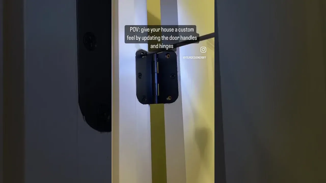 A black hinge fitted to a door edge, from a video on updating door handles and hinges